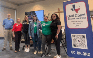 group standing in front of a sign about a disaster preparedness event
