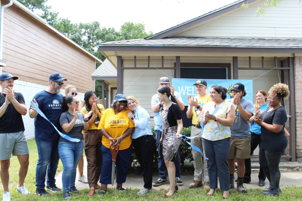 SBP and Farmers Insurance cheer on a homeowner whose home was rebuild after a disaster.